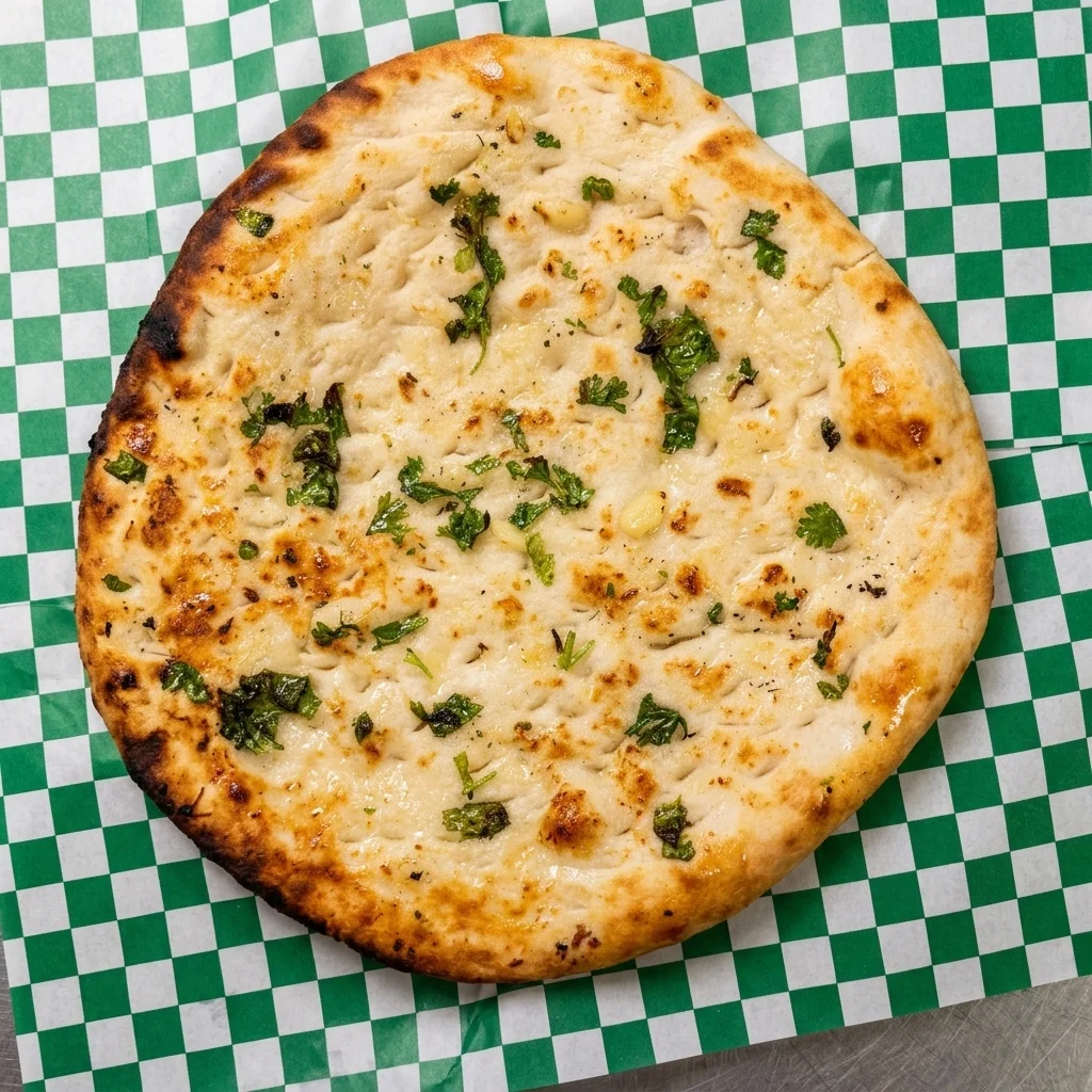 Garlic Naan — freshly baked tandoor bread with garlic and coriander at Chenab Edmonton